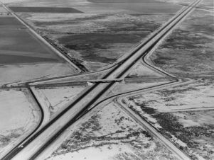 Interstate 10 southeast of Casa Grande, Arizona, 1967 Federal Highway Administration The new interstates that were built to connect the larger economic and populations centers by-passed the small towns business centers. Hotels, gas stations and restaurants relocated to the large interchanges. 